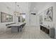 Spacious dining room with stylish chandelier, wood look floors, and views to the front yard at 12593 E Desert Cove Ave, Scottsdale, AZ 85259