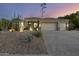 Charming desert home featuring xeriscape landscaping, a three car garage, and a tile roof at 12593 E Desert Cove Ave, Scottsdale, AZ 85259