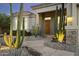 Desert home featuring a stone pathway, a xeriscaped front yard, and a covered entrance at 12593 E Desert Cove Ave, Scottsdale, AZ 85259