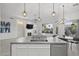 Open concept kitchen with marble countertops, stainless steel appliances, pendant lighting and living area with fireplace at 12593 E Desert Cove Ave, Scottsdale, AZ 85259