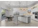 Bright kitchen features white cabinets, stainless steel appliances, marble countertops, and stylish pendant lighting at 12593 E Desert Cove Ave, Scottsdale, AZ 85259