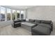 Spacious living room featuring stone accent wall, large windows, comfortable seating, and plenty of natural light at 12593 E Desert Cove Ave, Scottsdale, AZ 85259