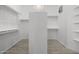 The walk-in closet has built-in shelving units to maximize storage and organization at 12593 E Desert Cove Ave, Scottsdale, AZ 85259