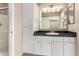 Bathroom vanity with granite countertops, bright vanity lights and white cabinets at 1295 N Ash St # 125, Gilbert, AZ 85233