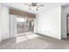 Bright bedroom with a ceiling fan and sliding glass door to the balcony at 1295 N Ash St # 125, Gilbert, AZ 85233