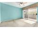 Bright bedroom with a ceiling fan and sliding glass door to the balcony at 1295 N Ash St # 125, Gilbert, AZ 85233