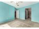 Bright bedroom with a ceiling fan and a doorway leading to a walk-in closet and bathroom at 1295 N Ash St # 125, Gilbert, AZ 85233