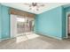 Bright bedroom with a ceiling fan and sliding glass door to the balcony at 1295 N Ash St # 125, Gilbert, AZ 85233