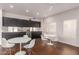 Sleek common room with stylish black cabinets, modern white tables and chairs, and lots of sunlight at 1295 N Ash St # 125, Gilbert, AZ 85233