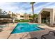 Sparkling community pool with ample seating, clubhouse, and palm trees under a blue sky at 1295 N Ash St # 125, Gilbert, AZ 85233