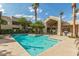 Resort-style pool and spa area with clubhouse and lush landscaping under clear blue skies at 1295 N Ash St # 125, Gilbert, AZ 85233