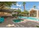Relaxing community pool and spa area featuring shaded seating and lush landscaping at 1295 N Ash St # 125, Gilbert, AZ 85233