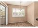 Cozy dining area with sliding glass doors to the balcony and a contemporary chandelier at 1295 N Ash St # 125, Gilbert, AZ 85233