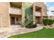Exterior of a building featuring balconies and green-painted stairs, surrounded by lawn and landscape at 1295 N Ash St # 125, Gilbert, AZ 85233