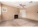 Spacious living room with fireplace, ceiling fan, and large windows for ample natural light at 1295 N Ash St # 125, Gilbert, AZ 85233