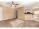 Open living space with a ceiling fan, sliding door to balcony, and a breakfast bar at 1295 N Ash St # 125, Gilbert, AZ 85233