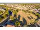 Aerial view of neighborhood showcasing a grassy common area bordering a residential street with mountain views at 1409 W Maria Ln, Tempe, AZ 85284