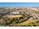 Expansive aerial view of the residential neighborhood featuring lush greenery, community parks, and mountain views at 1409 W Maria Ln, Tempe, AZ 85284