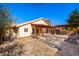 Expansive backyard featuring a covered patio, brick and stone paving and desert landscaping at 1409 W Maria Ln, Tempe, AZ 85284