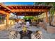 Outdoor living space with a covered patio, outdoor kitchen, fire pit, and dining area at 1409 W Maria Ln, Tempe, AZ 85284