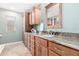 Well-appointed bathroom with custom cabinetry, granite countertops, and a decorative mirror at 1409 W Maria Ln, Tempe, AZ 85284