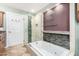 A luxurious bathroom with a soaking tub and separate glass enclosed shower with designer tile at 1409 W Maria Ln, Tempe, AZ 85284