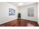 Bedroom features hardwood floors and a bright window at 1409 W Maria Ln, Tempe, AZ 85284