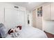 Comfortable bedroom with a large sliding closet, stuffed animals, and plush bedding at 1409 W Maria Ln, Tempe, AZ 85284