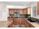 This kitchen features custom cabinetry, granite countertops, and stainless steel appliances at 1409 W Maria Ln, Tempe, AZ 85284