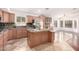 Well-lit kitchen features granite countertops, stainless steel appliances, and a large central island at 1409 W Maria Ln, Tempe, AZ 85284