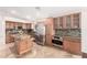 Well-lit kitchen with stainless steel appliances, custom cabinets, granite countertops, and a kitchen island at 1409 W Maria Ln, Tempe, AZ 85284