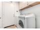 Functional laundry room featuring washer, dryer, and storage cabinets at 1409 W Maria Ln, Tempe, AZ 85284