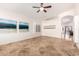 Bright and airy living room featuring tile flooring, white walls, and artistic decor at 1409 W Maria Ln, Tempe, AZ 85284