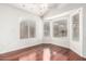Bright living room with hardwood floors, white walls, and multiple windows for ample natural light at 1409 W Maria Ln, Tempe, AZ 85284