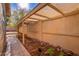 Enclosed side yard with custom canvas covered patio, brick trim and desert rock landscaping at 1409 W Maria Ln, Tempe, AZ 85284