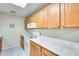 Well-lit kitchen featuring white appliances, light countertops, and ample cabinet space at 14300 W Bell Rd # 142, Surprise, AZ 85374