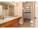 Bathroom featuring wood cabinets, a large mirror, tile flooring, and a walk-in closet at 1585 E Jeanne Ln, San Tan Valley, AZ 85140