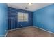 Bright bedroom features blue accent wall with geometric design, and neutral carpet at 1585 E Jeanne Ln, San Tan Valley, AZ 85140