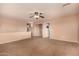 Bonus Room features a ceiling fan and a door leading to another room, with neutral carpet at 1585 E Jeanne Ln, San Tan Valley, AZ 85140