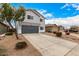 Gray two-story home with a two-car garage, complemented by desert landscaping and a lengthy driveway at 1585 E Jeanne Ln, San Tan Valley, AZ 85140