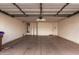 A spacious garage with a single overhead light fixture and concrete flooring at 1585 E Jeanne Ln, San Tan Valley, AZ 85140