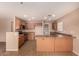 A kitchen featuring wood cabinets, neutral countertops, tile flooring, and stainless steel appliances at 1585 E Jeanne Ln, San Tan Valley, AZ 85140