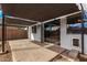 A covered back patio with concrete flooring and sliding glass doors for indoor/outdoor living at 1585 E Jeanne Ln, San Tan Valley, AZ 85140
