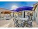 Inviting outdoor dining area with a pergola, built-in grill, and comfortable seating at 17813 N Encanto Dr, Surprise, AZ 85374