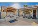 Backyard BBQ area with a built-in grill, pergola, and seating for outdoor entertainment at 17813 N Encanto Dr, Surprise, AZ 85374