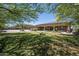 Expansive backyard featuring a basketball court, fountain, and covered patio at 18131 W Palo Verde Ct, Litchfield Park, AZ 85340