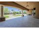 Covered patio showcasing a manicured lawn, palm trees, and a basketball court at 18131 W Palo Verde Ct, Litchfield Park, AZ 85340
