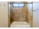 Tiled bathroom with a shower and tub combination offering a relaxing and luxurious experience at 18131 W Palo Verde Ct, Litchfield Park, AZ 85340