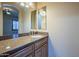 Bathroom with double vanity with granite counters and tiled flooring at 18131 W Palo Verde Ct, Litchfield Park, AZ 85340