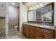 Beautiful bathroom vanity with granite counters and a framed mirror at 18131 W Palo Verde Ct, Litchfield Park, AZ 85340